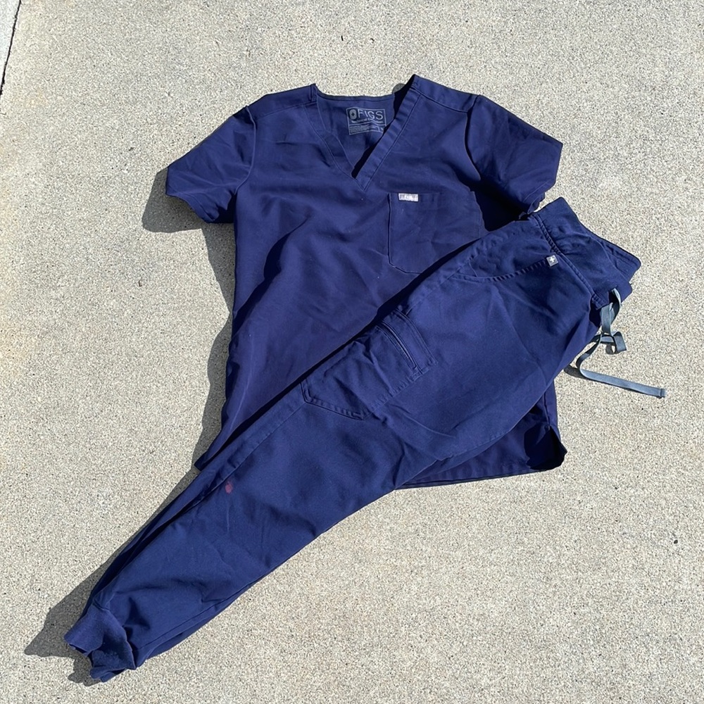 Blue Small Figs scrubs jogger pants with one stain on leg